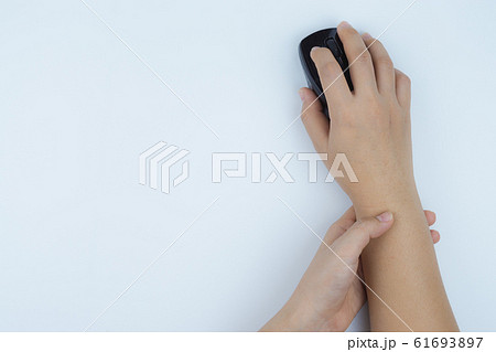 Closeup woman holds her wrist pain from using computer on white background. Health care concept. Closeup woman holds her wrist pain from using computer on white background. Health care concept. 61693897