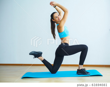Beautiful smiling woman doing yoga indoors in gym 61694081