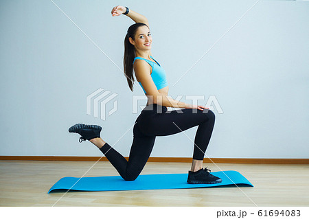 Beautiful smiling woman doing yoga indoors in gym 61694083