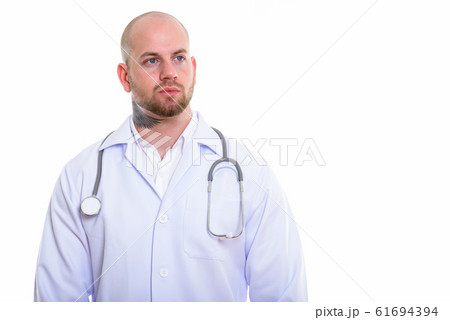 Studio shot of young bald muscular man doctor 61694394