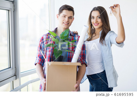 Portrait of young couple moving in new home Portrait of young couple moving in new home 61695595