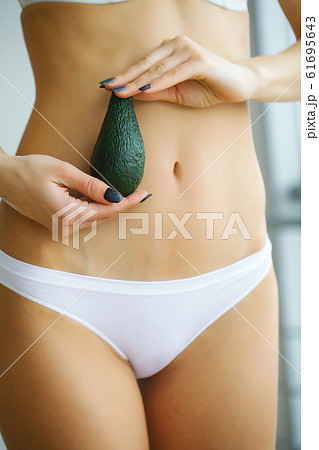 Close Up Of Woman Wearing Underwear Holding Slice Of Brown Bread