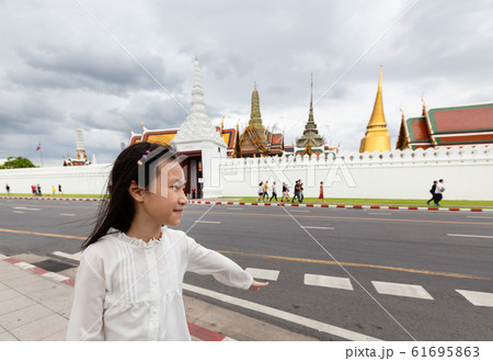 Asian cute girl walking on street of city,Wat Phra Kaew or Wat Phra Si Rattana Satsadaram background,Bangkok,Thailand,travel concept 61695863