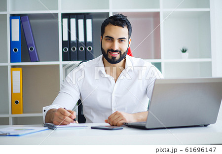 Young Business Man Working On Computer In Office. Young Business Man Working On Computer In Office. 61696147