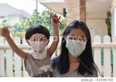 mother and kid wearing face mask protect air dust pollution with pm 2.5 mother and kid wearing face mask protect air dust pollution with pm 2.5 61696780