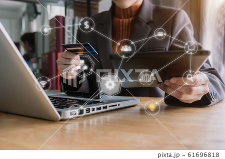 Women using laptop and mobile phone to online shopping and pay by credit card in home office. Women using laptop and mobile phone to online shopping and pay by credit card in home office. 61696818
