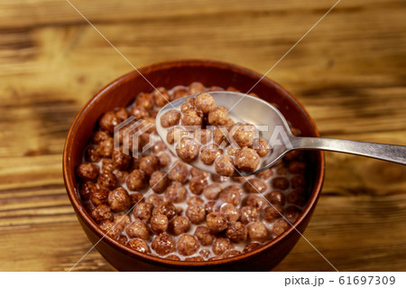 Cereal chocolate balls with milk in a bowl Cereal chocolate balls with milk in a bowl 61697309