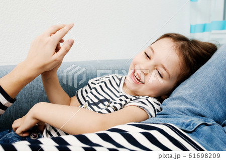 Adorable little girl in striped clothes smiling Adorable little girl in striped clothes smiling 61698209