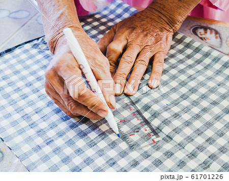 Senior woman hand design with Sewing equipment laptop and smartphone on white background Senior woman hand design with Sewing equipment laptop and smartphone on white background 61701226