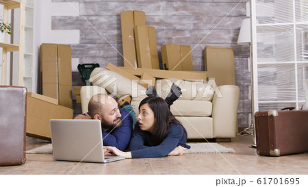 Couple laying down on the floor of their new apartment Couple laying down on the floor of their new apartment 61701695