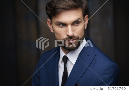 indoor photo of young handsome stylish businessman wearing suit indoor photo of young handsome stylish businessman wearing suit 61701740
