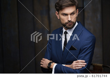 indoor photo of young handsome stylish businessman wearing suit indoor photo of young handsome stylish businessman wearing suit 61701744