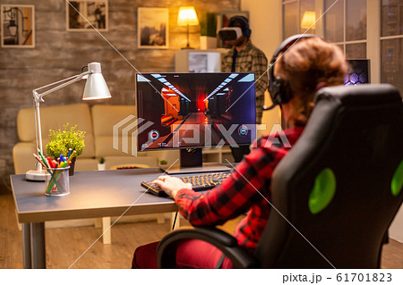 Professional video gamer female playing an online shooter game 61701823