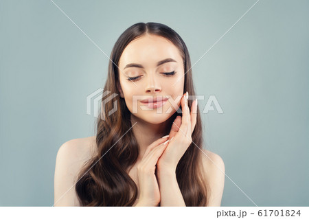 Beautiful woman touching her skin her hand on blue 61701824