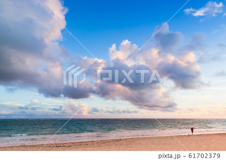 A man walks the beach of Bavaro at sunrise 61702379