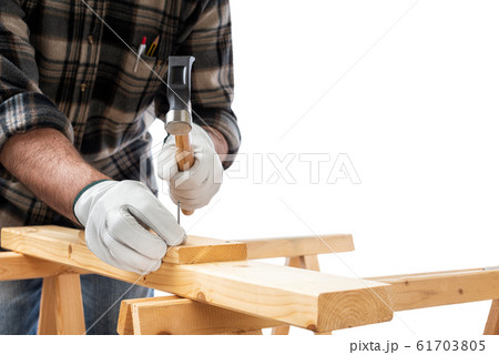 Carpenter at work on wooden boards. Carpentry. 61703805