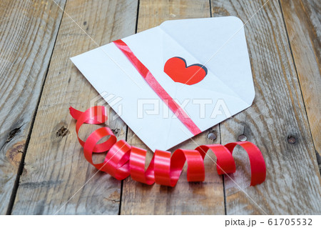 heart in a white envelope and a rose for heart in a white envelope and a rose for 61705532