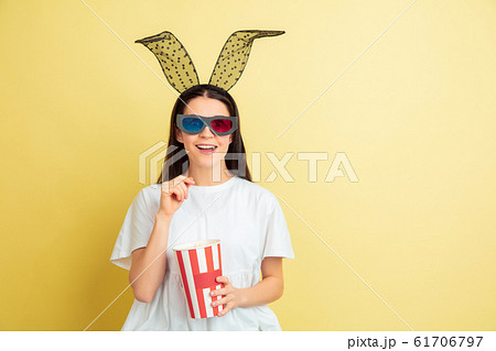 Easter bunny woman with bright emotions on yellow studio background Easter bunny woman with bright emotions on yellow studio background 61706797