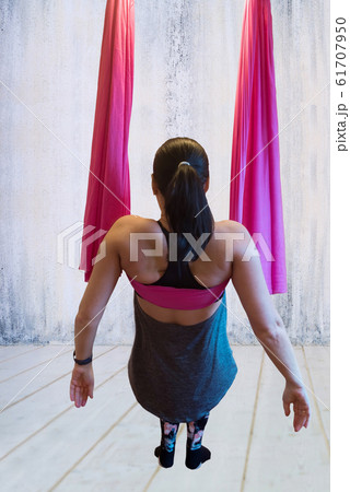 Young woman making antigravity yoga exercises Young woman making antigravity yoga exercises 61707950
