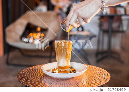 Iced coffee with milk in tall glasses. Iced coffee with milk in tall glasses. 61708469