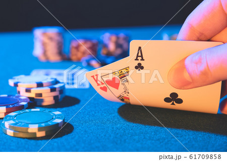 Man plays poker in the casino Man plays poker in the casino 61709858