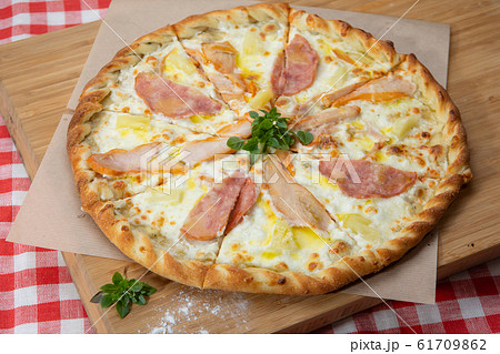 Pizza with different sausages close-up with different ingredients decorated with Basil 61709862