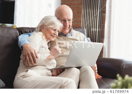 Senior couple browsing the internet together Senior couple browsing the internet together 61709974