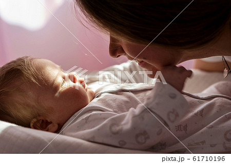 Beautiful closeup of mother and newborn baby on soft background. 61710196