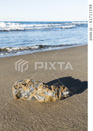 used plastic bottle on the sand of a beach 61711598