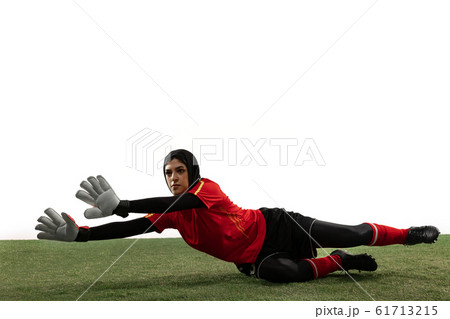 Arabian female soccer or football player, goalkeeper on white studio background 61713215