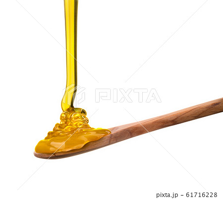 Falling and flowing honey on a wooden spoon isolated on white with clipping path Falling and flowing honey on a wooden spoon isolated on white with clipping path 61716228