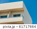 Modern new building with open balconies against the summer blue sky 61717664