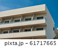 Modern new building with open balconies against the summer blue sky 61717665