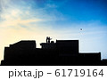 Children on the rooftop play with kites. 61719164