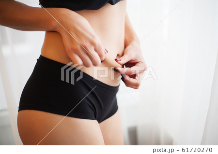 Weight Loss. Closeup Of Hot Sexy Female With Hand Pinching Skin 61720270