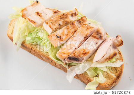 Caesar salad toast with lettuce and chicken slices 61720878
