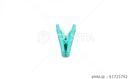 The close up of light green clothes peg on white background. 61725762