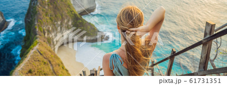 Family vacation lifestyle. Happy woman stand at viewpoint. Look at beautiful beach under high cliff 61731351