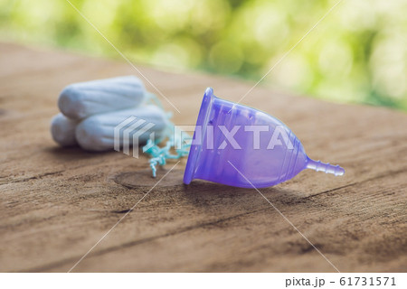 Different types of feminine hygiene products - menstrual cup and tampons Different types of feminine hygiene products - menstrual cup and tampons 61731571