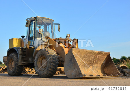 Front-end loader working on construction site Front-end loader working on construction site 61732015