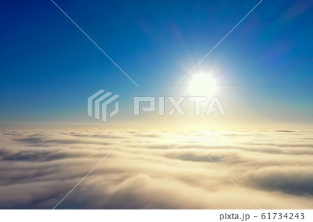 Bright sun in the blue sky over the horizon Bright sun in the blue sky over the horizon 61734243