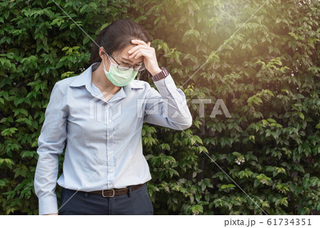 Young asian woman wearing glasses and face hygienic mask protect filter pm2.5 anti pollution. Young asian woman wearing glasses and face hygienic mask protect filter pm2.5 anti pollution. 61734351