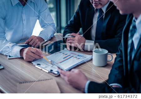 three businessman looking at graph in paper and talk about business plan, marketing and financial in the future. concept of business success, business meeting. 61734372