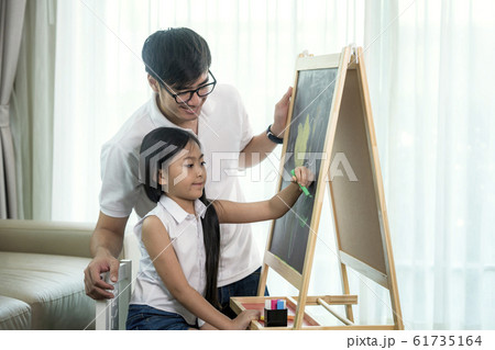 Asian teacher teach he student to draw a flower in 61735164