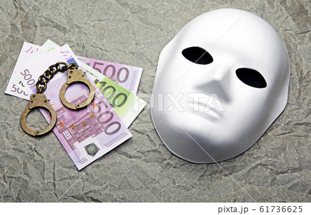money banknote handcuffs mask parchment paper background 61736625