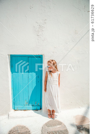 Adorable little girl at old street of typical greek traditional village 61736629