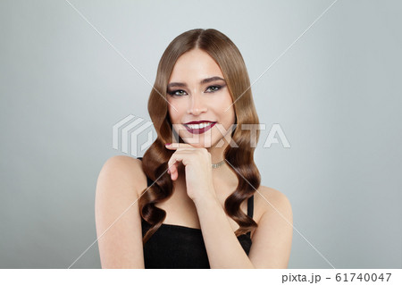 Young glamorous model woman with shiny brown curly Young glamorous model woman with shiny brown curly 61740047