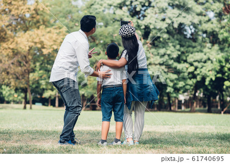 Happy children and parents playing in the park. 61740695