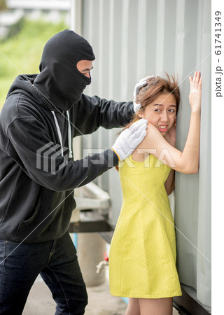 Bandit wear black mask with a knife attacks a girl Bandit wear black mask with a knife attacks a girl 61741349
