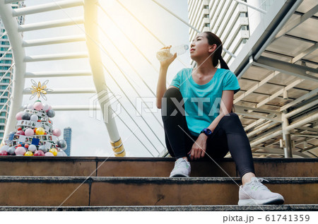 Beautiful fitness athlete asian woman drinking Beautiful fitness athlete asian woman drinking 61741359